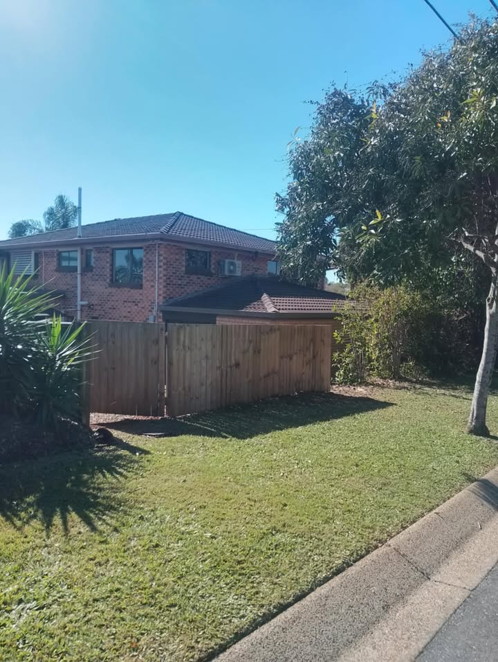 Clean Redlands front yard with new timber fence and tidy lawn after tree work