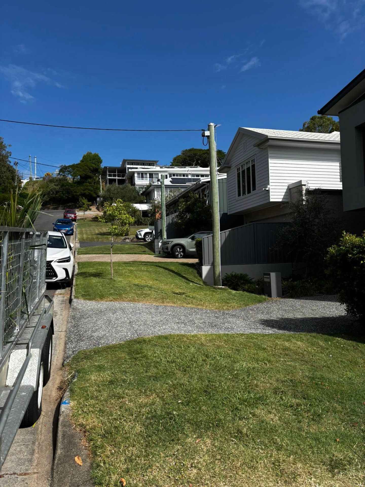 Clear sky and tidy driveway after palm removal